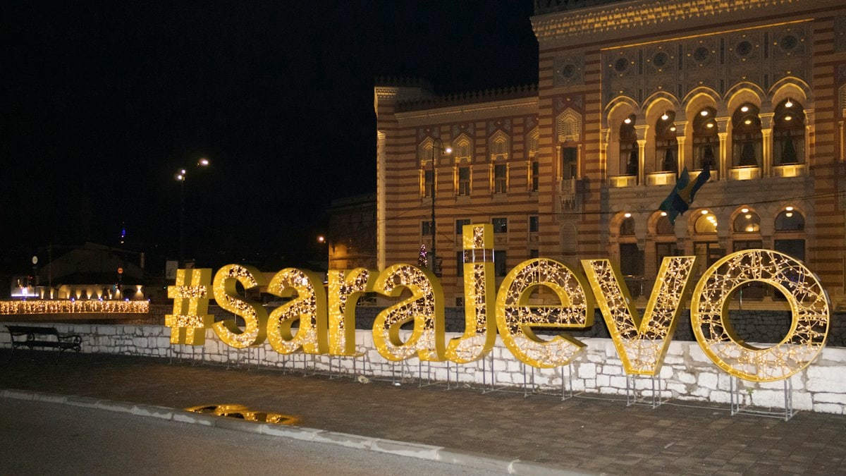 a large sign that says love is lit up in front of a building